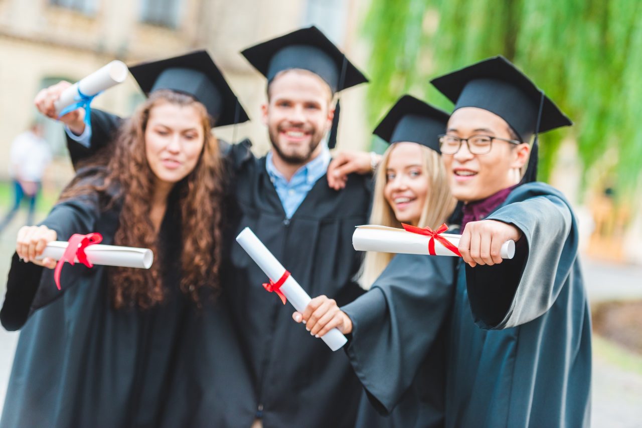 portrait-of-happy-multiracial-graduates-with-diplomas-on-street.jpg